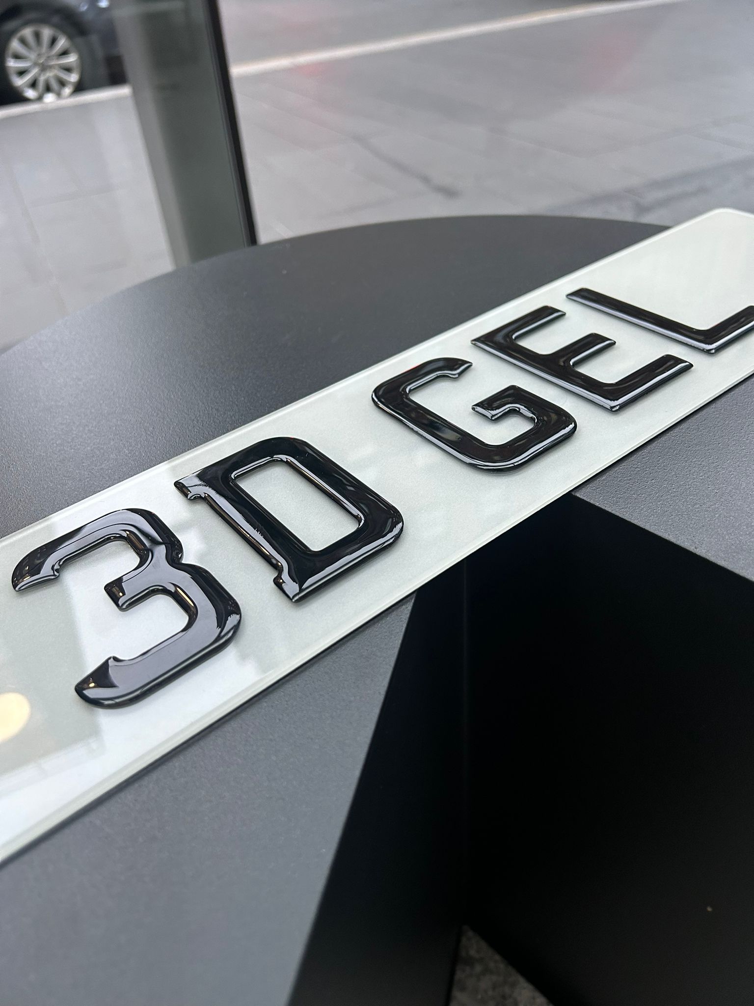 A detailed close-up of a 3D Gel number plate, highlighting the smooth, raised gel characters.